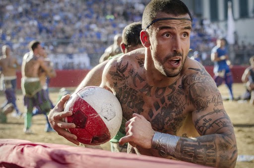 Based on the original medieval version of football (soccer) created in 16th Century Florence, Calcio Storico translates to “historic football” but might be more accurately described as prison riot football.